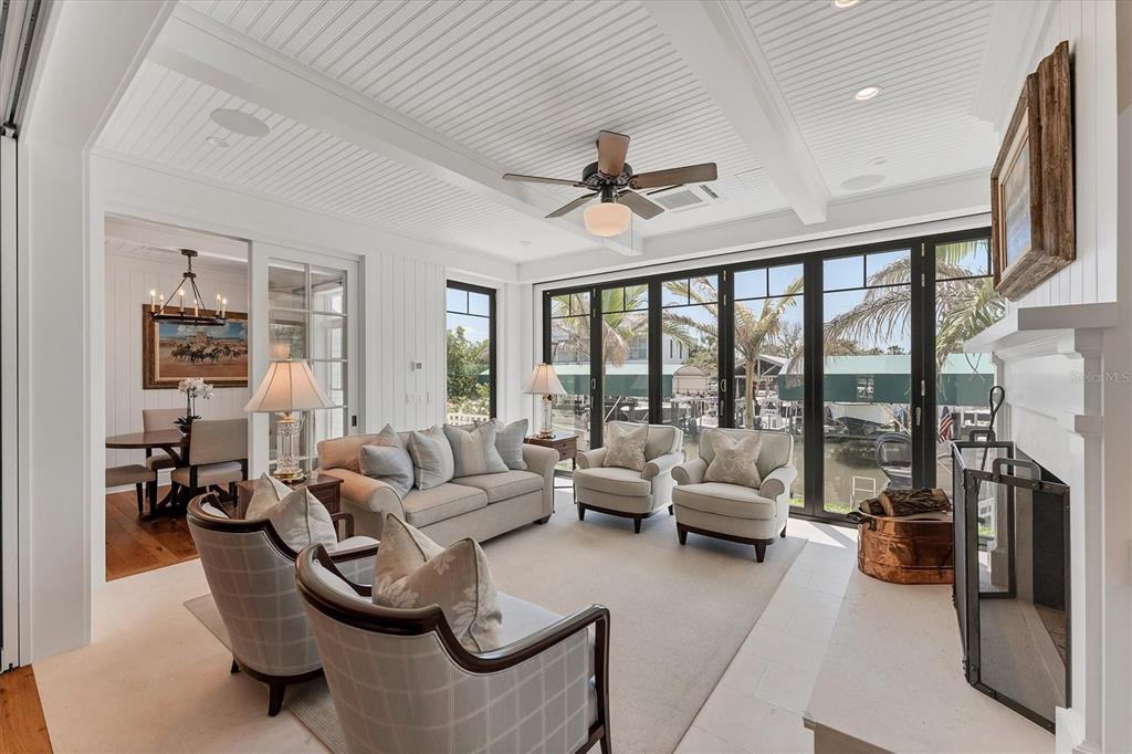 150 1st Street East Boca Grande, FL 33921 - Photo 19 of 72 a living room with furniture large windows and a fireplace