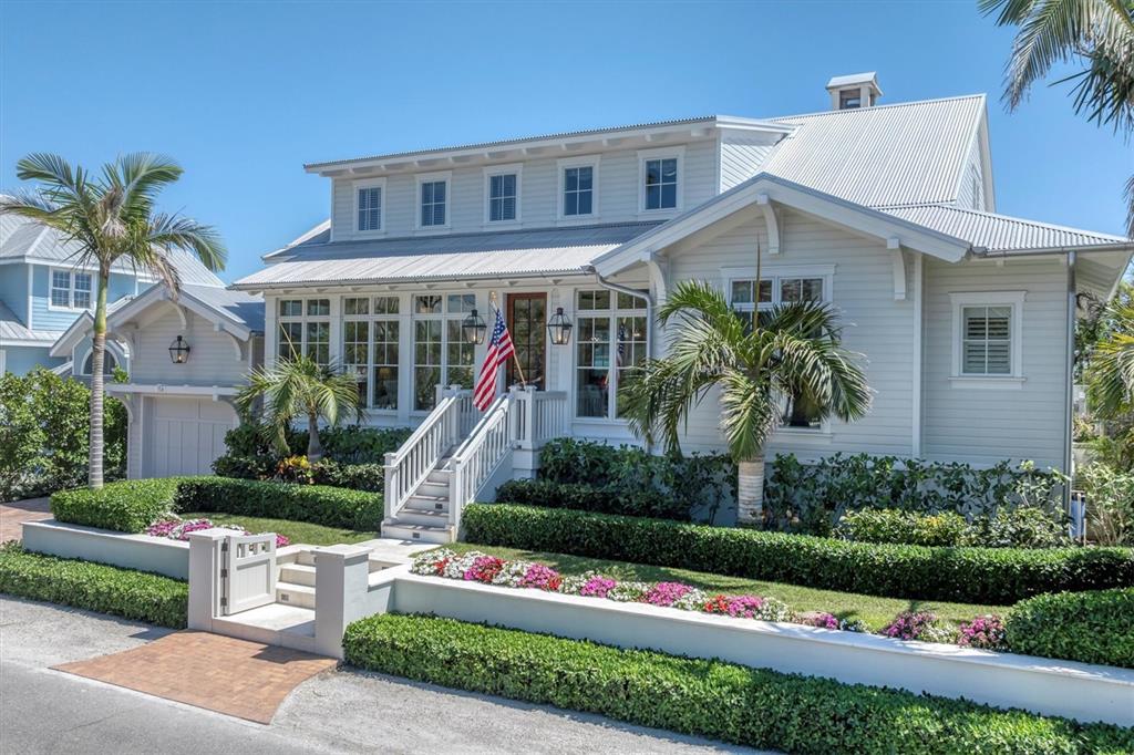 150 1st Street East Boca Grande, FL 33921 - Photo 2 of 72 a front view of a house with a small yard and potted plants