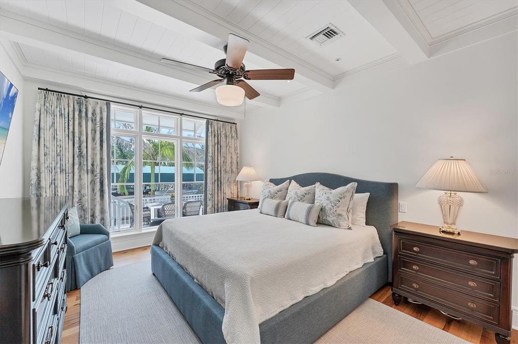 150 1st Street East Boca Grande, FL 33921 - Photo 26 of 72 a bedroom with a bed and a chandelier