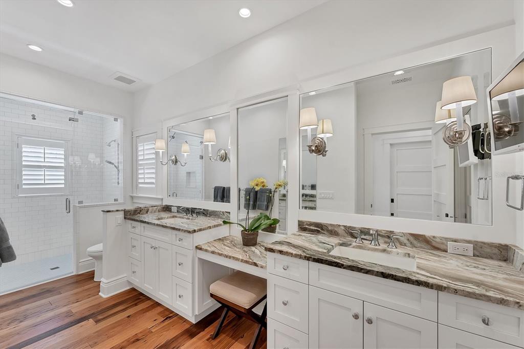 150 1st Street East Boca Grande, FL 33921 - Photo 28 of 72 a bathroom with a granite countertop sink a mirror and a shower