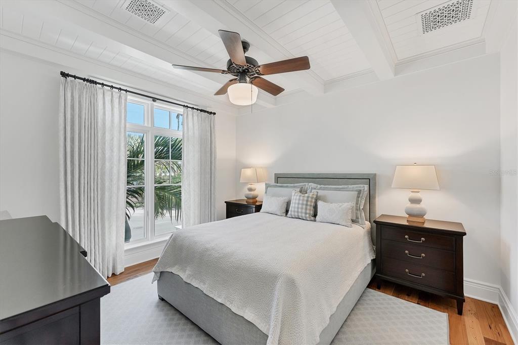150 1st Street East Boca Grande, FL 33921 - Photo 30 of 72 a bedroom with a large bed and a chandelier