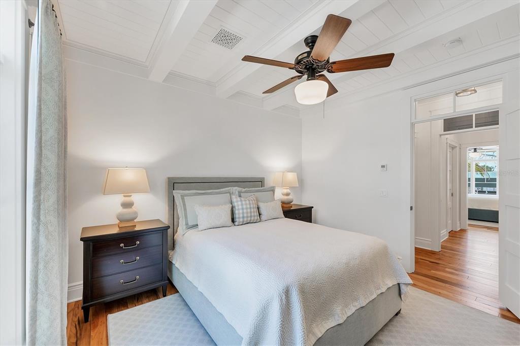 150 1st Street East Boca Grande, FL 33921 - Photo 31 of 72 a bedroom with a bed and a chandelier