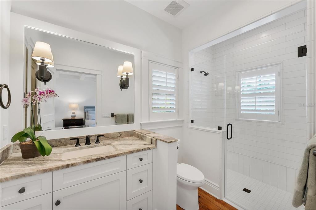 150 1st Street East Boca Grande, FL 33921 - Photo 32 of 72 a bathroom with a granite countertop sink mirror and shower
