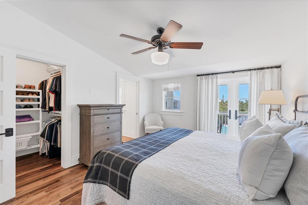 150 1st Street East Boca Grande, FL 33921 - Photo 36 of 72 a bedroom with a bed and a chandelier