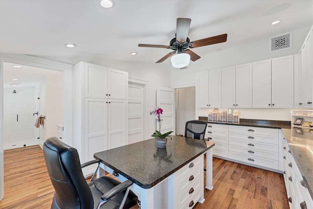 150 1st Street East Boca Grande, FL 33921 - Photo 40 of 72 a kitchen with stainless steel appliances kitchen island granite countertop a table chairs in it and wooden floors