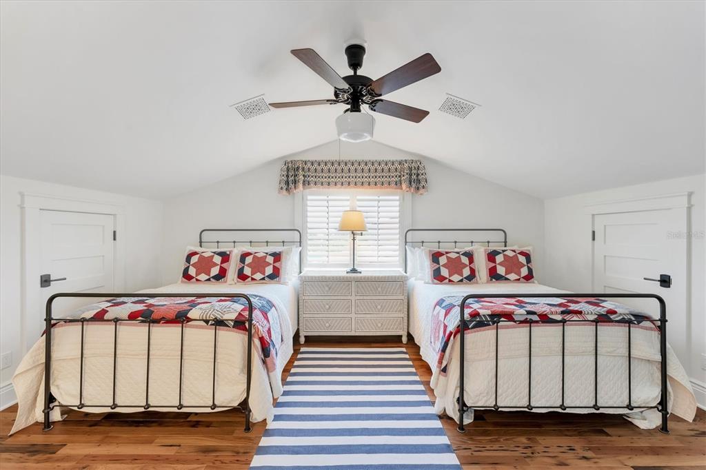 150 1st Street East Boca Grande, FL 33921 - Photo 43 of 72 a bedroom with three beds and a window