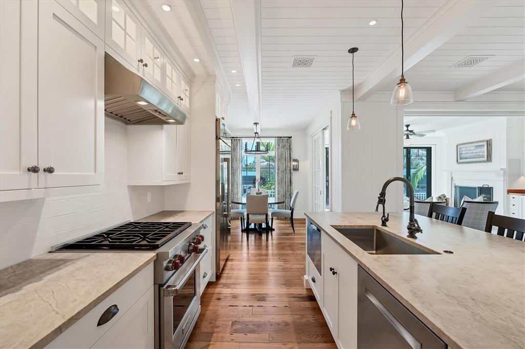 150 1st Street East Boca Grande, FL 33921 - Photo 10 of 72 a kitchen with stainless steel appliances granite countertop a sink a stove and a wooden floors
