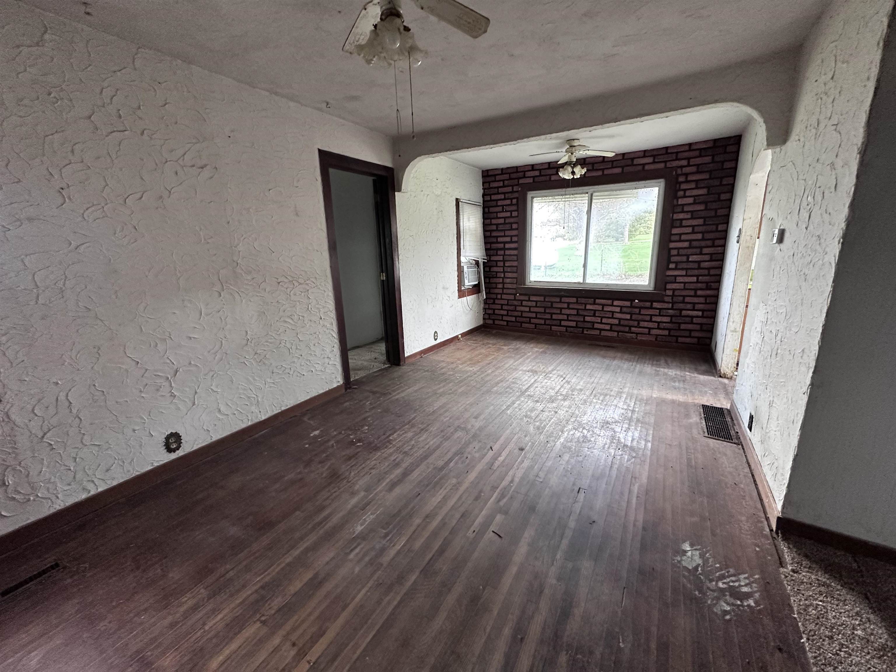2855 West Florence Road Freeport, IL 61032 - Photo 3 of 13 an empty room with wooden floor and windows