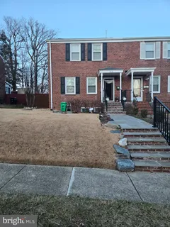 front view of a brick house with a yard