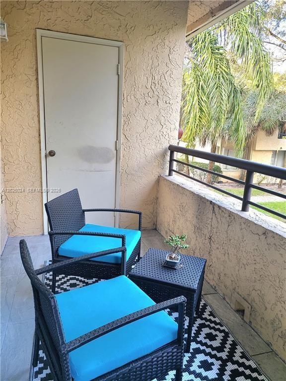 631 Lyons Road, Unit 12205 Coconut Creek, FL 33063 - Photo 6 of 14 a view of a dining room with furniture window and outside view