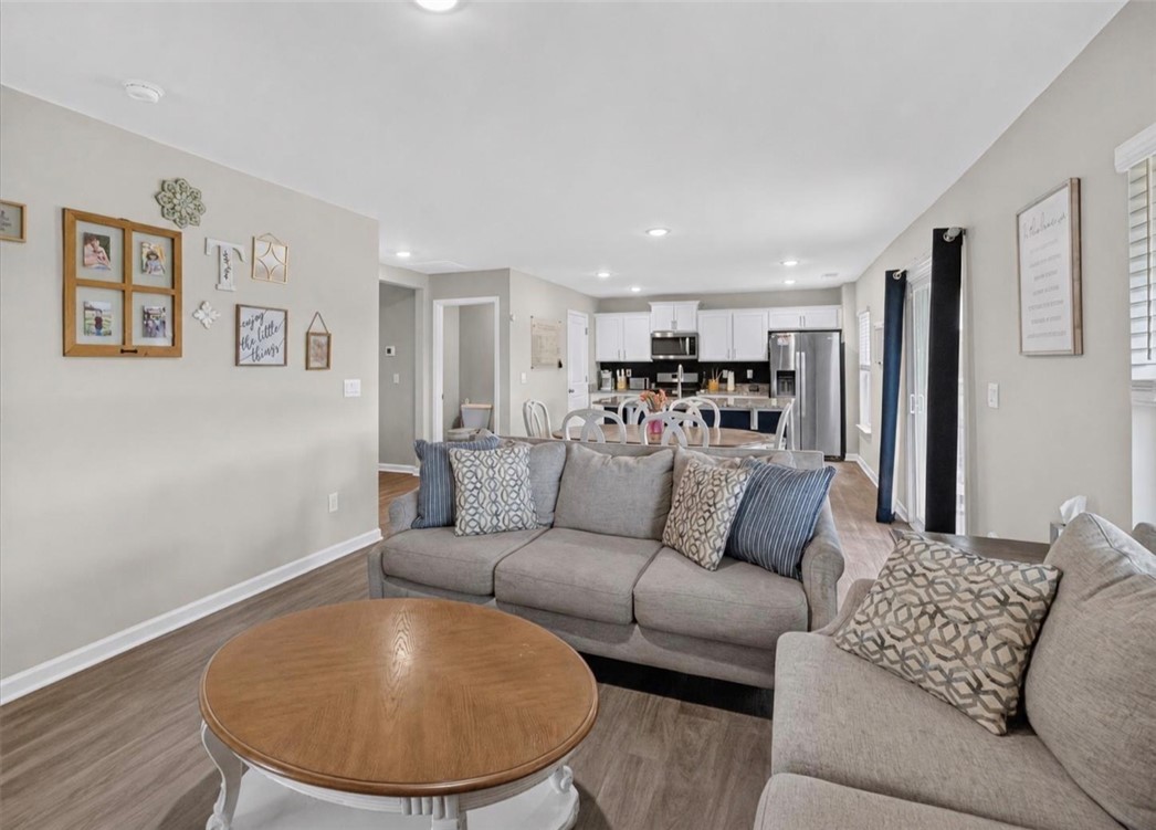 213 Millhone Way Pendleton, SC 29670 - Photo 4 of 25 An inviting open-concept living area flows seamlessly into a modern kitchen, creating an ideal space for daily living and entertaining.