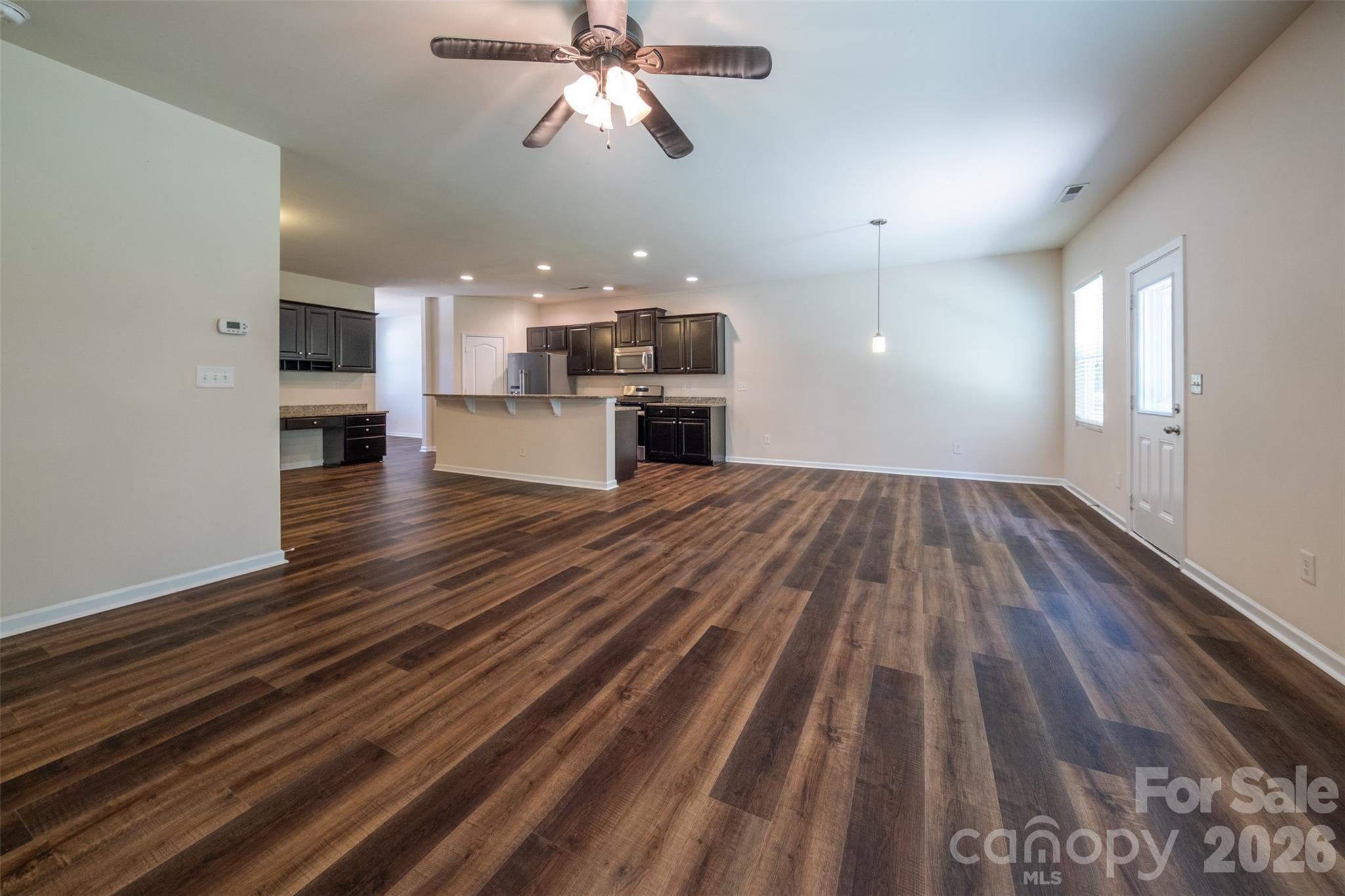 3006 Houndscroft Road Indian Trail, NC 28079 - Photo 17 of 39 a view of a room with kitchen island and wooden floor