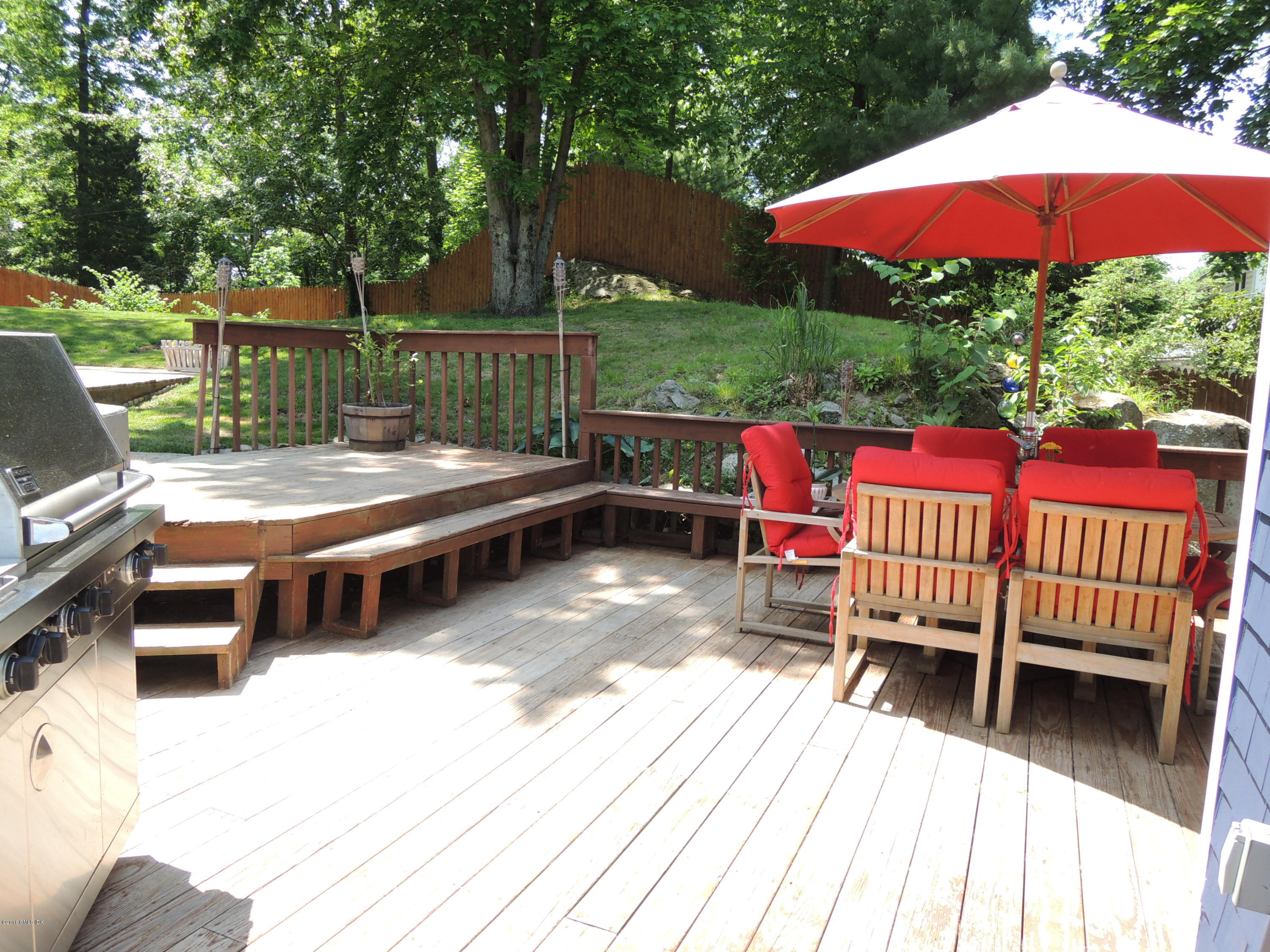 31 Bonwit Road Riverside, CT 06878 - Photo 28 of 31 a view of a patio with a table and chairs under an umbrella