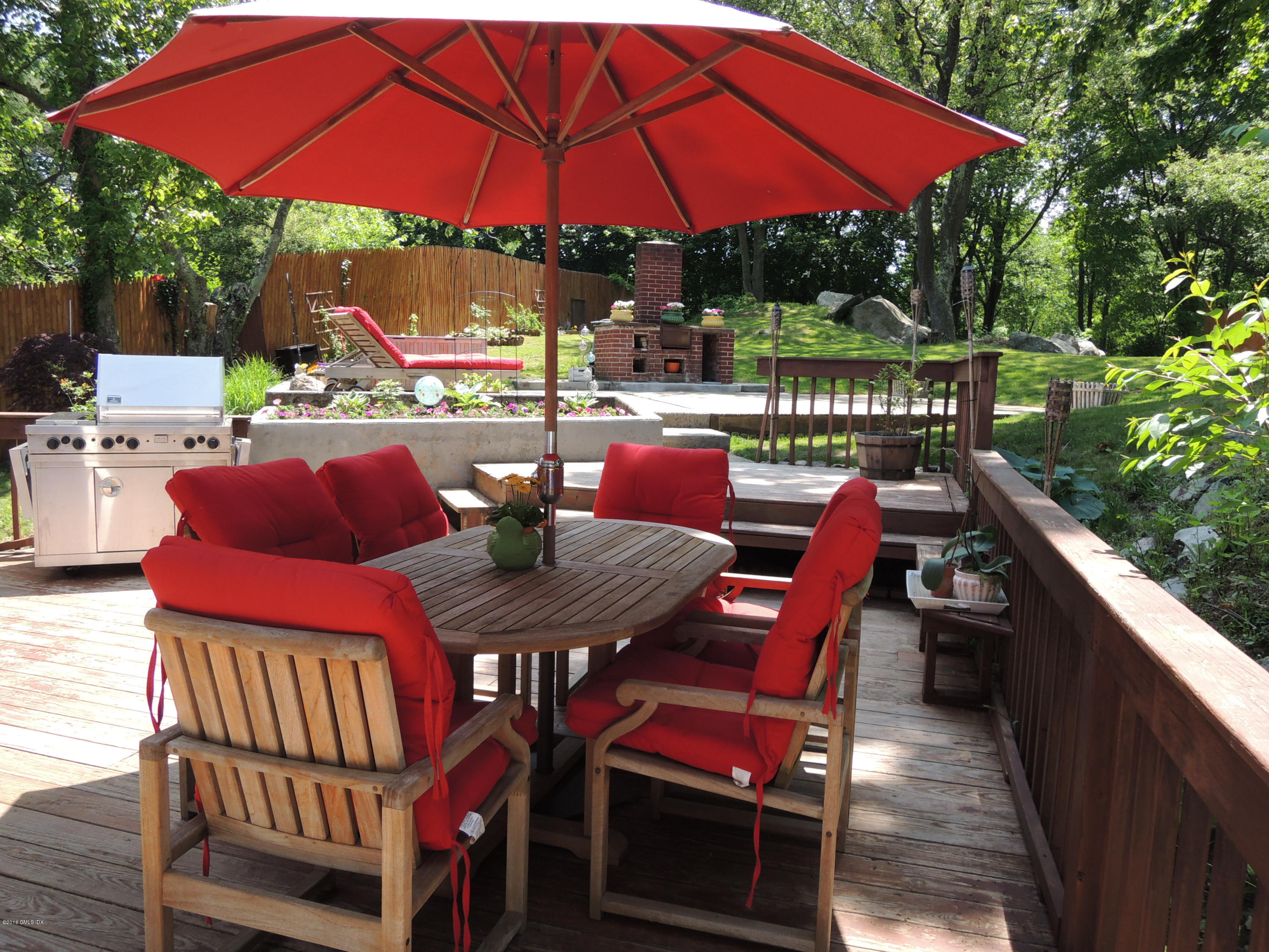 31 Bonwit Road Riverside, CT 06878 - Photo 29 of 31 a patio with a table and chairs under an umbrella