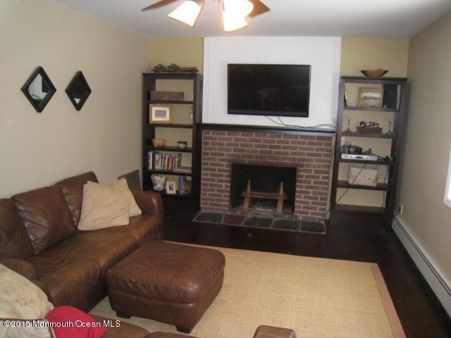 67 Aberdeen Road Matawan, NJ 07747 - Photo 8 of 17 a living room with furniture a flat screen tv and a fireplace