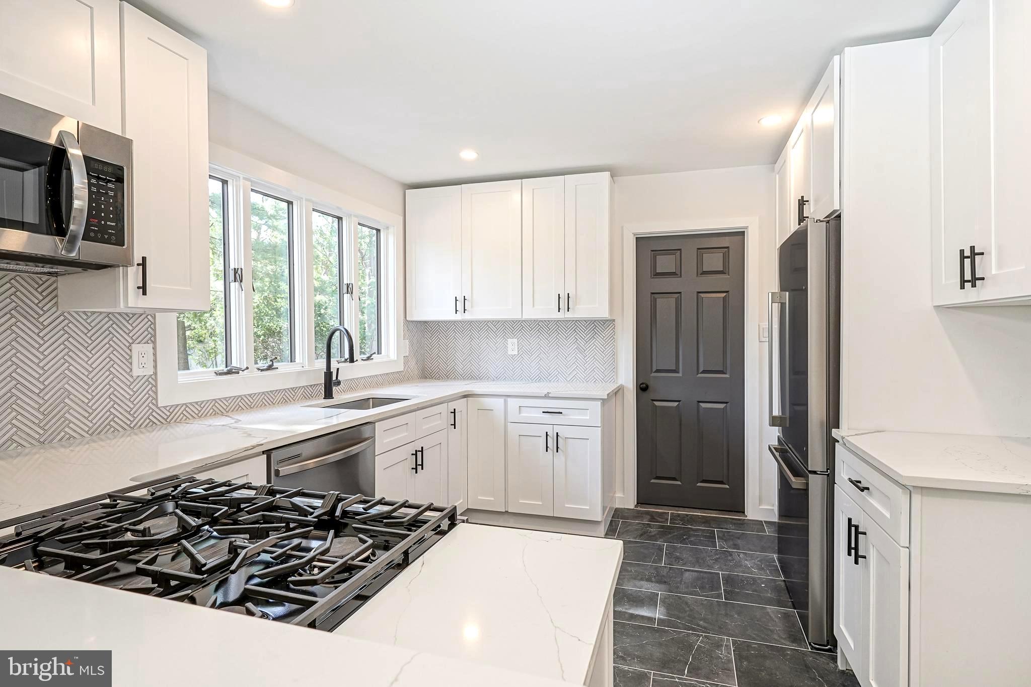 511 Boundary Road Pitman, NJ 08071 - Photo 11 of 36 a kitchen with a sink stove and refrigerator