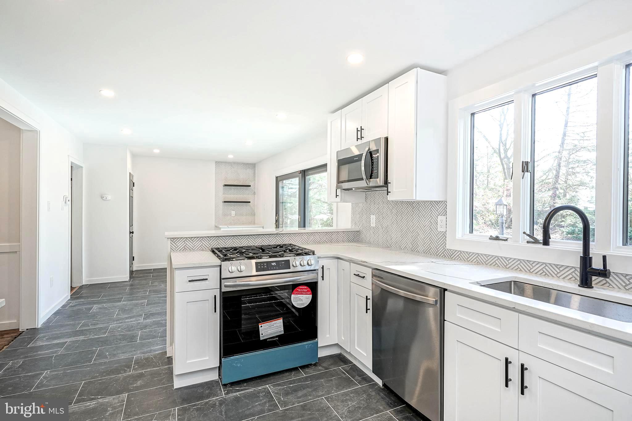 511 Boundary Road Pitman, NJ 08071 - Photo 13 of 36 a kitchen with a stove top oven sink and window