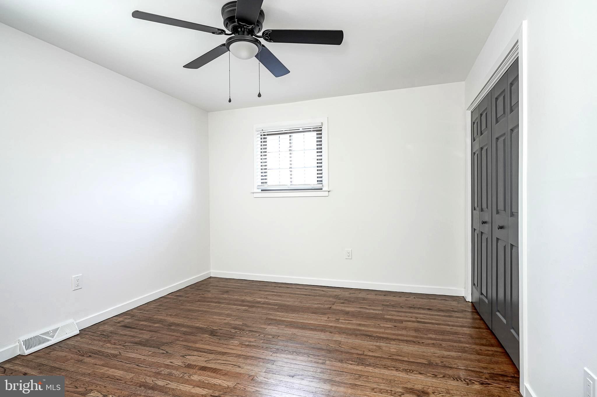 511 Boundary Road Pitman, NJ 08071 - Photo 23 of 36 a view of an empty room with wooden floor and a ceiling fan
