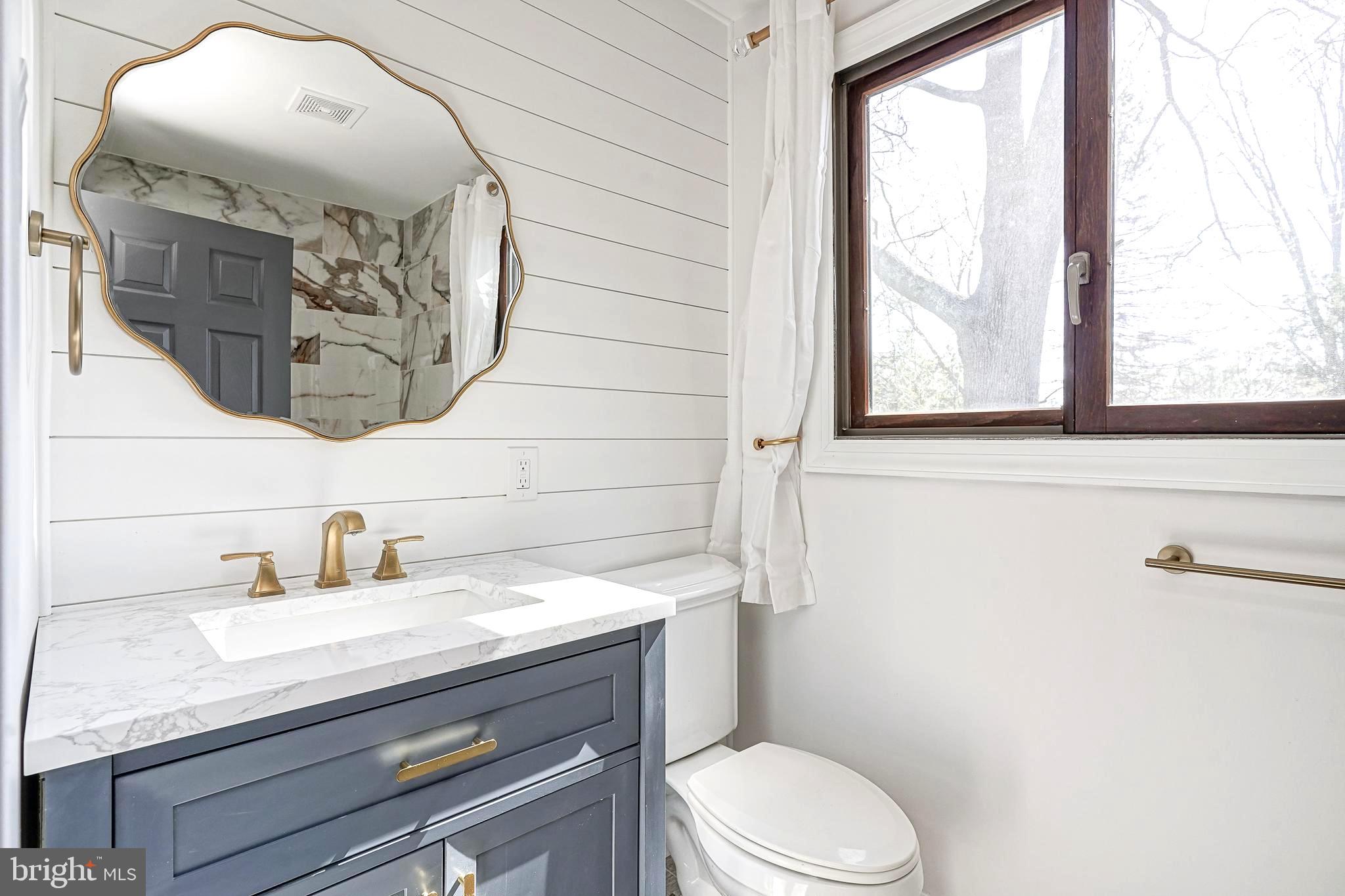 511 Boundary Road Pitman, NJ 08071 - Photo 25 of 36 a bathroom with a granite countertop sink mirror vanity and toilet
