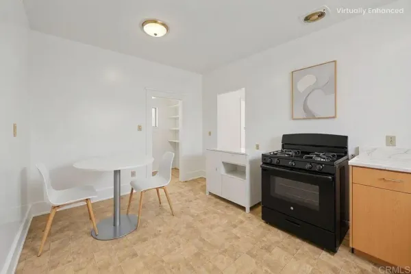 a kitchen with a stove sink and cabinets