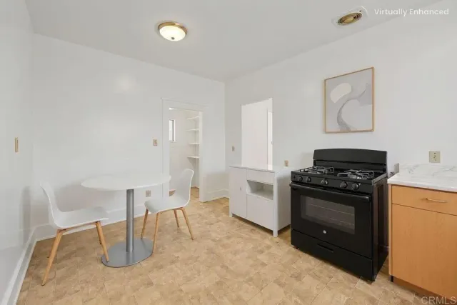 a kitchen with a stove sink and cabinets