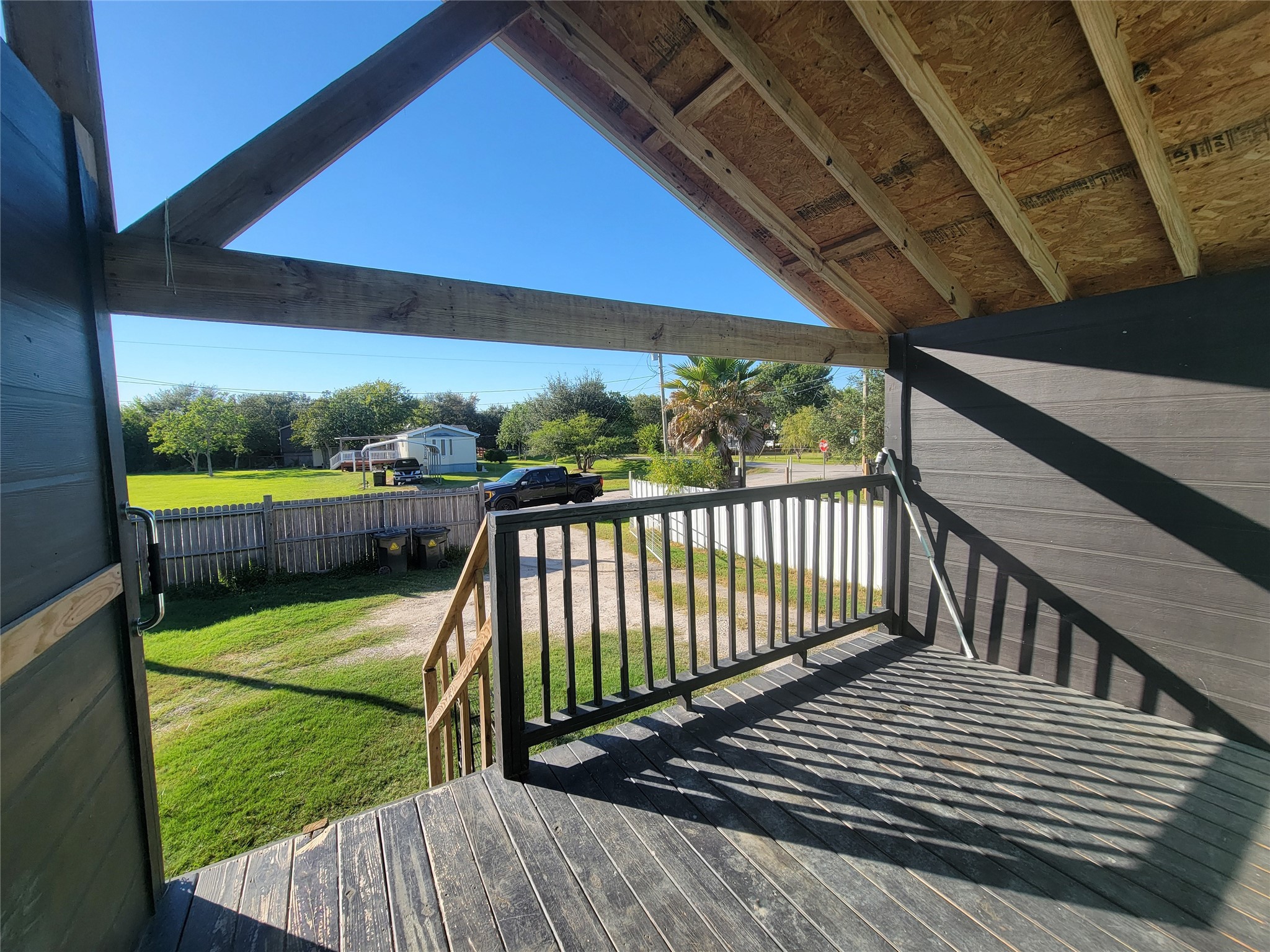 715 11th Street, Unit A Dickinson, TX 77539 - Photo 11 of 14 This photo showcases a covered wooden patio in front.