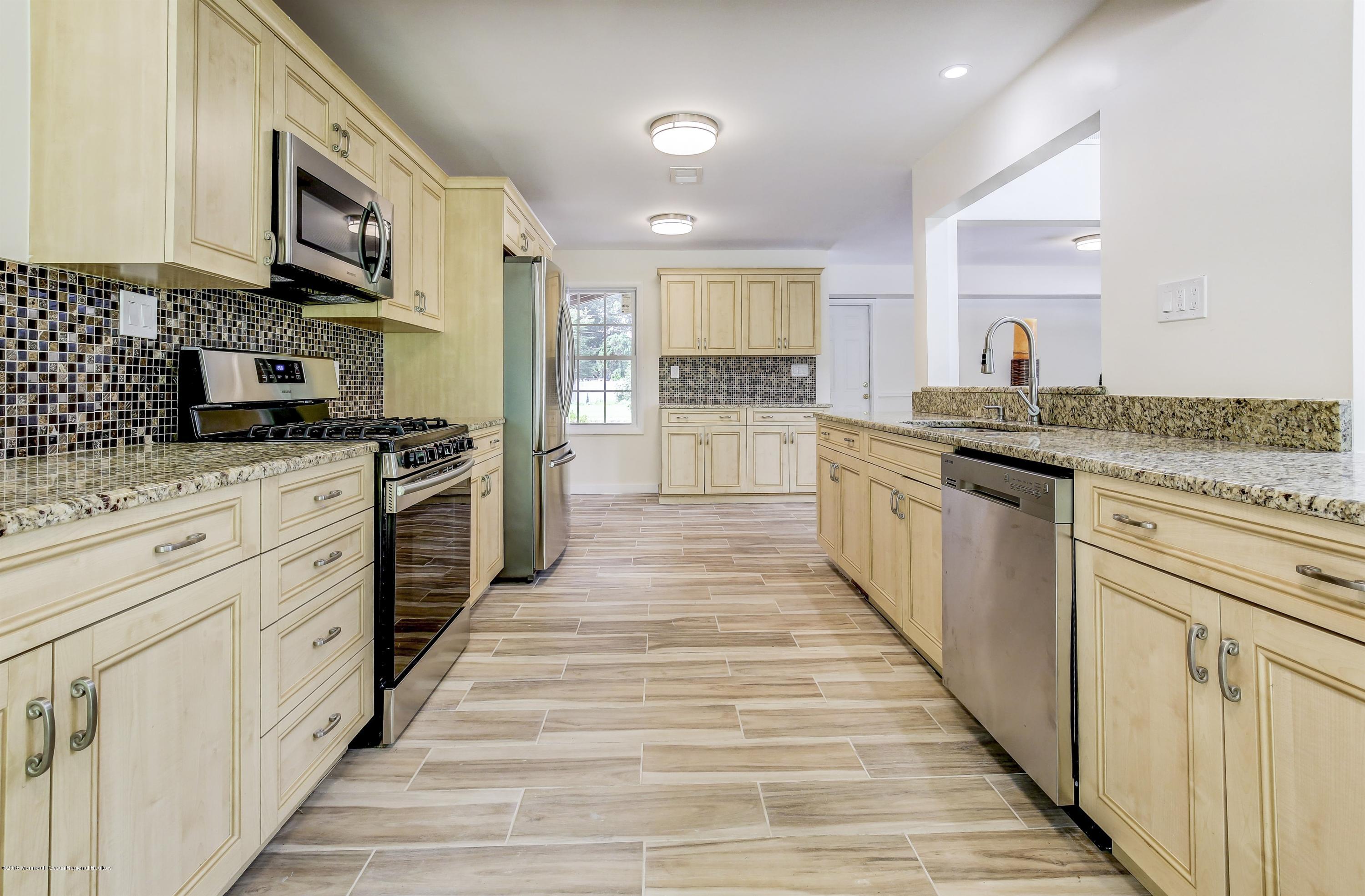 38 Dutch Valley Road Howell, NJ 07731 - Photo 1 of 20 a large kitchen with stainless steel appliances granite countertop a stove and a sink