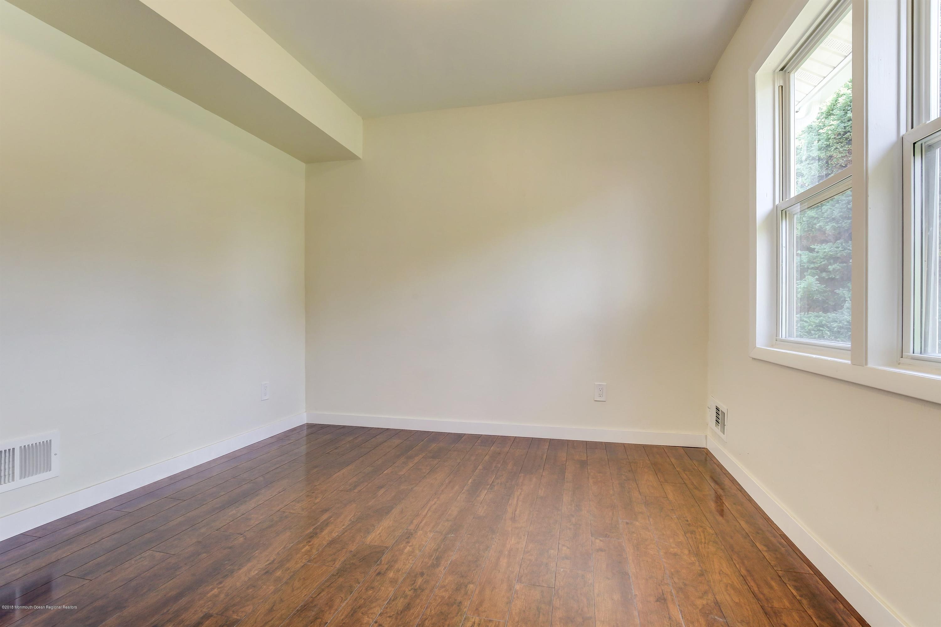 38 Dutch Valley Road Howell, NJ 07731 - Photo 15 of 20 wooden floor in an empty room with a window