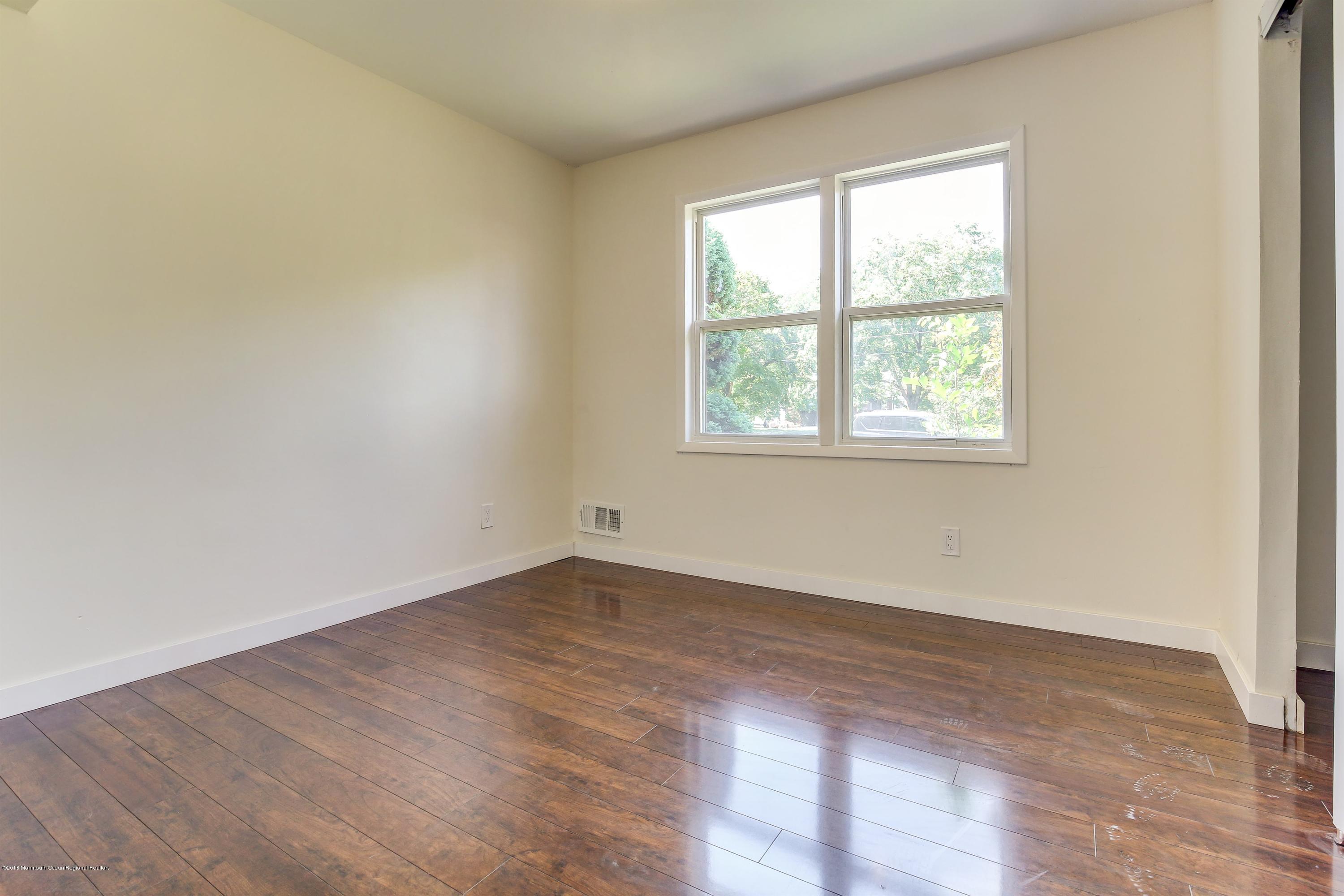 38 Dutch Valley Road Howell, NJ 07731 - Photo 16 of 20 an empty room with wooden floor and windows