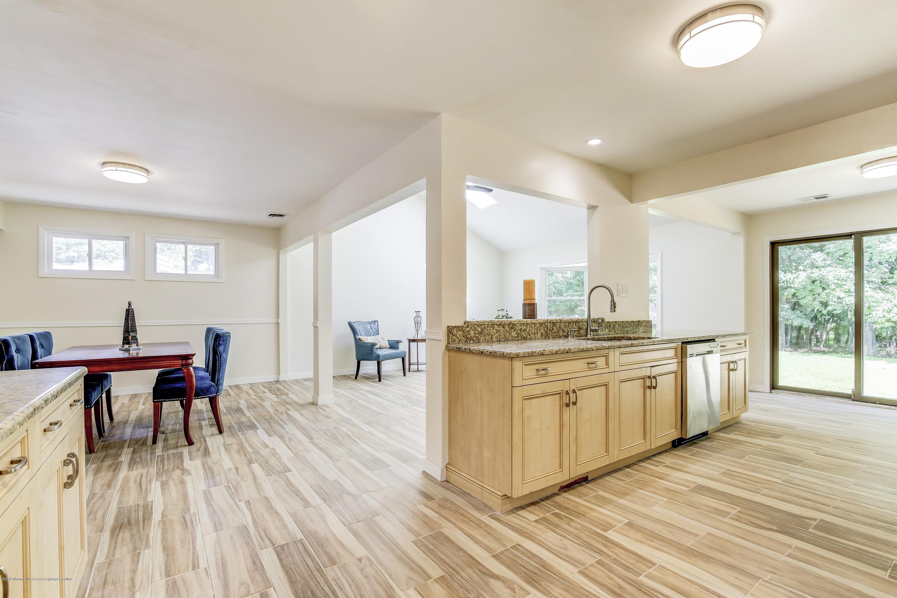 38 Dutch Valley Road Howell, NJ 07731 - Photo 4 of 20 a large kitchen with kitchen island a sink table and chairs