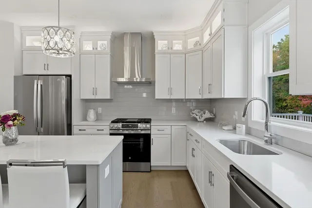 a kitchen with stainless steel appliances granite countertop a sink stove and refrigerator