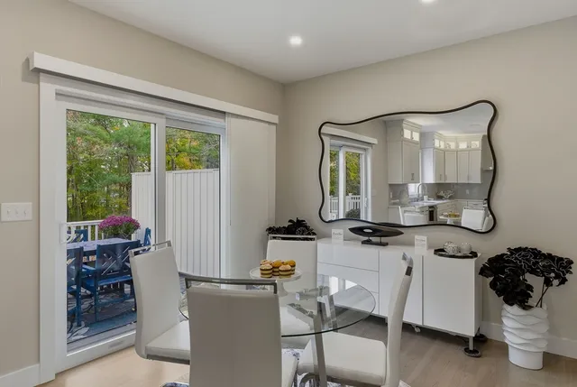 a view of a dining room with furniture a chandelier and wooden floor