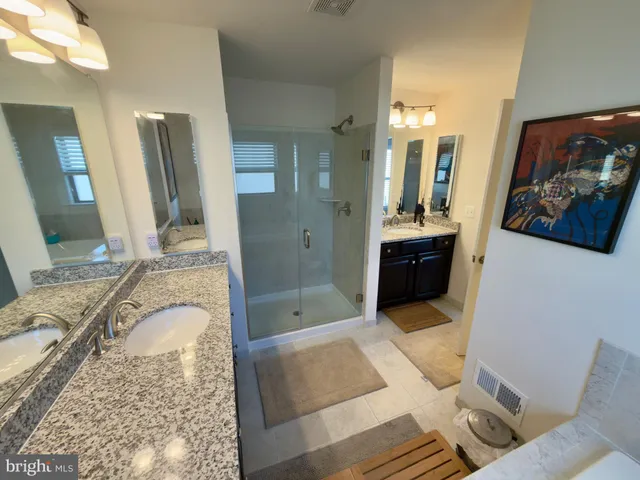 a bathroom with a tub shower and sink