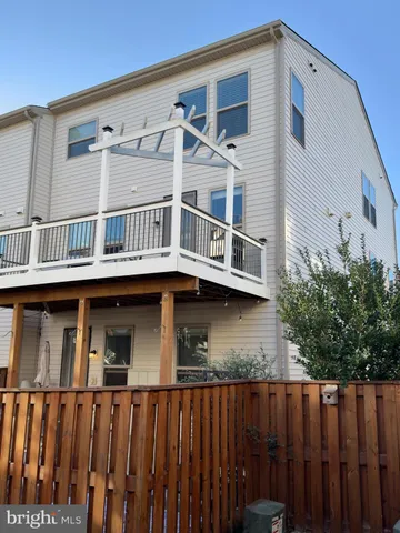 a front view of a house with wooden deck