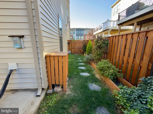 a view of a back yard of the house with a garden