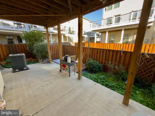 a view of backyard with outdoor seating and plants