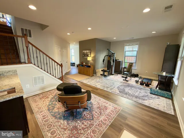 a living room with wooden floor and a table