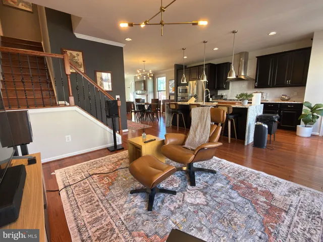 a living room with dining room and kitchen view