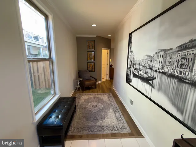 a view of a hallway and a livingroom with furniture