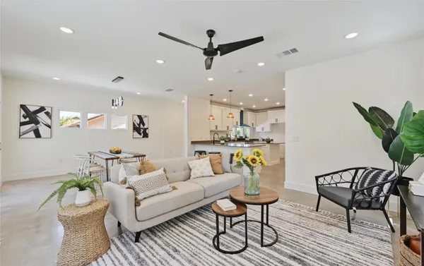 a living room with furniture and kitchen view