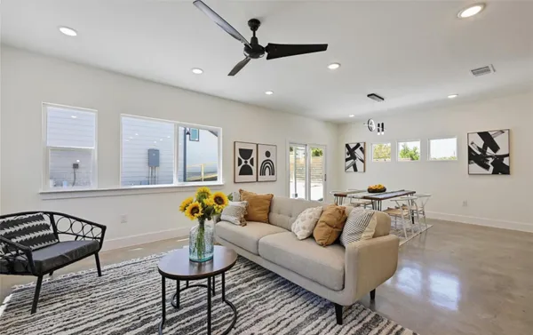a living room with furniture and wooden floor