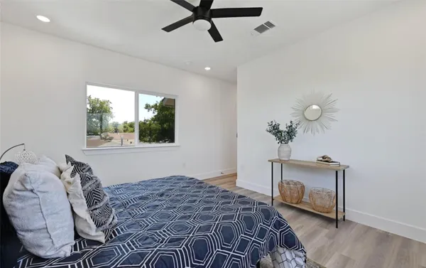a bedroom with a bed and a window