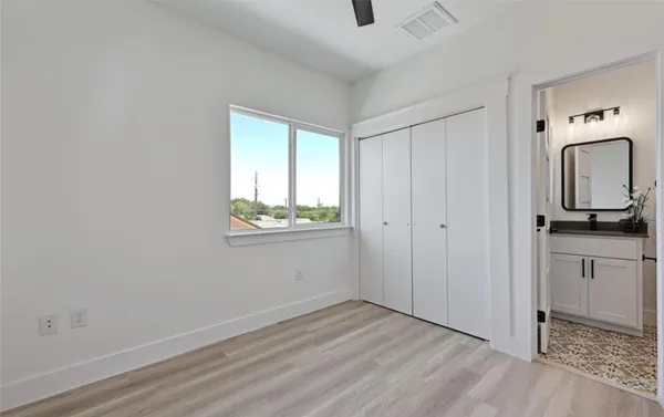 a view of a livingroom with wooden floor and a window
