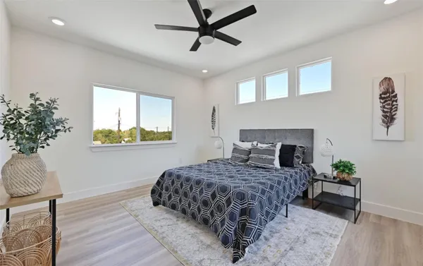 a bedroom with a bed and a potted plant