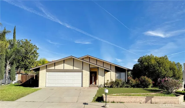 a view of a white house with a yard