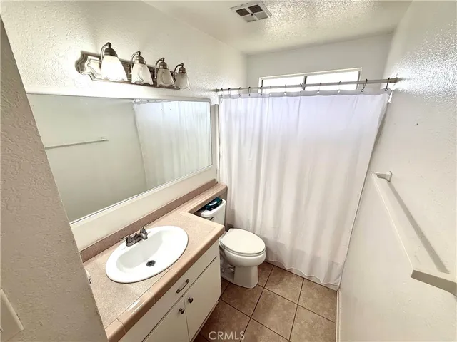 a bathroom with a sink toilet and a mirror