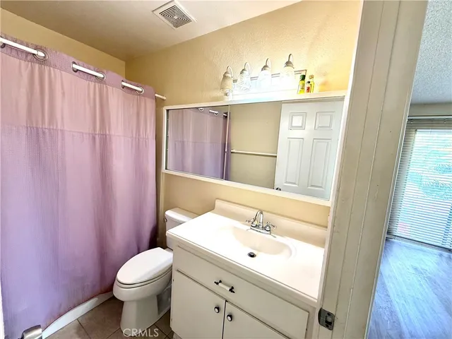 a bathroom with a sink a mirror and a toilet