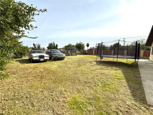 a view of swimming pool with outdoor seating and a lots of green space