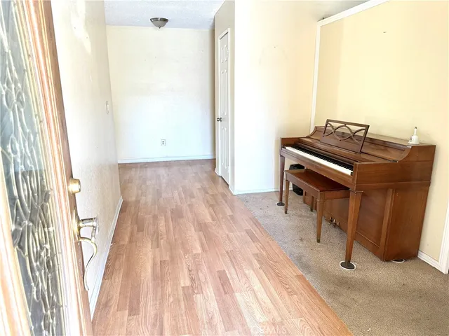 a view of a bedroom with wooden floor