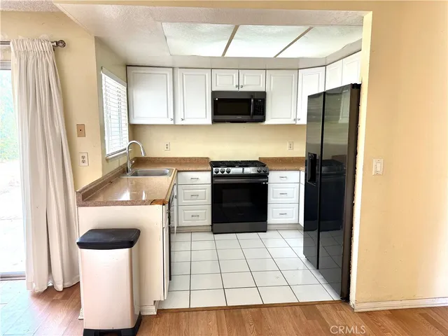 a kitchen with a refrigerator and a stove top oven